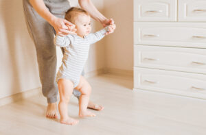 Baby,Taking,First,Steps,With,Mother,Help